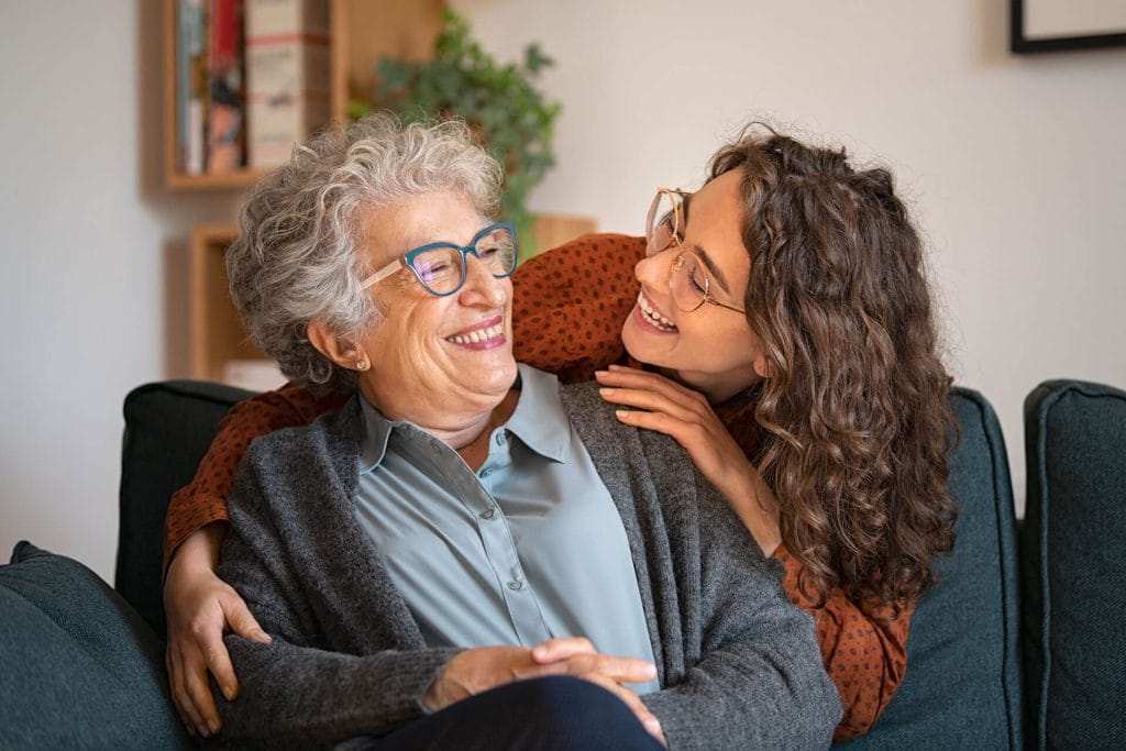 A woman and her adult daughter embrace