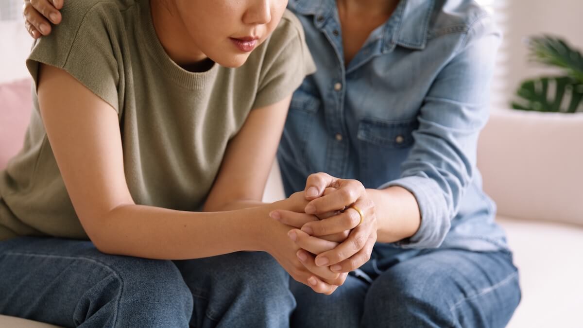 Woman being comforted.